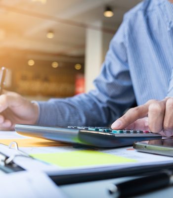 Business finance man calculating budget numbers, Invoices and financial adviser working.